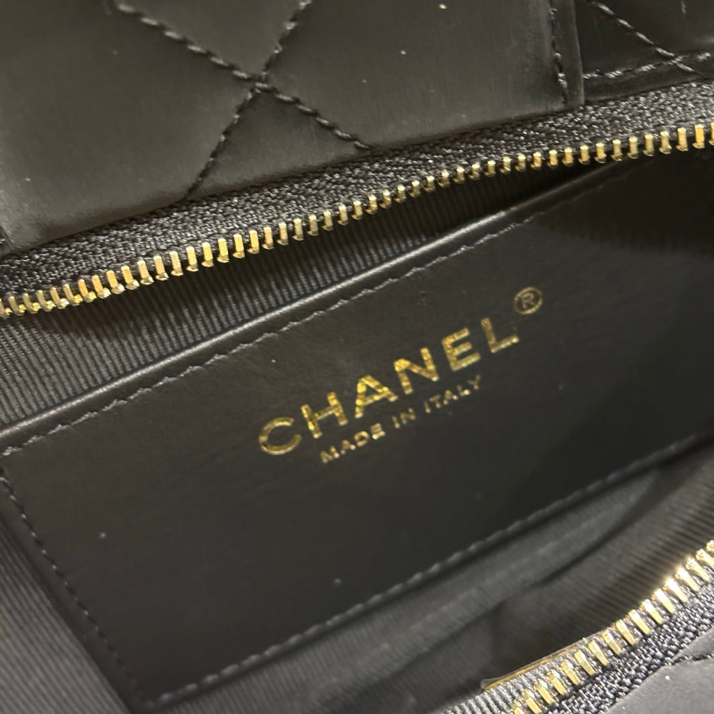 Chanel black quilted bow bag interior label detail