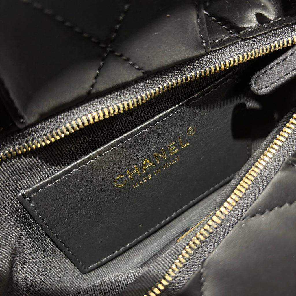 Chanel black quilted bow bag interior craftsmanship detail