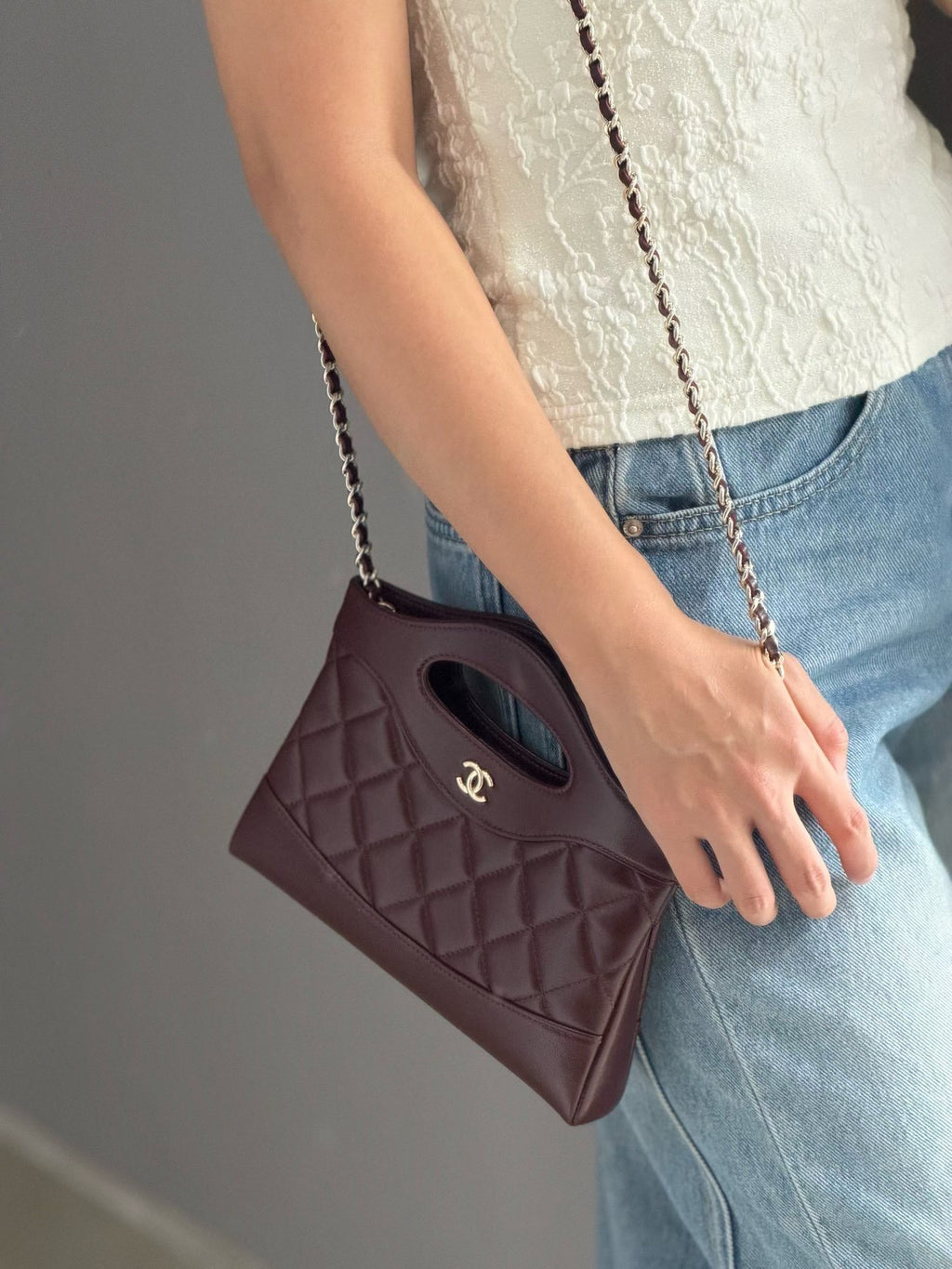 Burgundy quilted mini handbag shoulder view