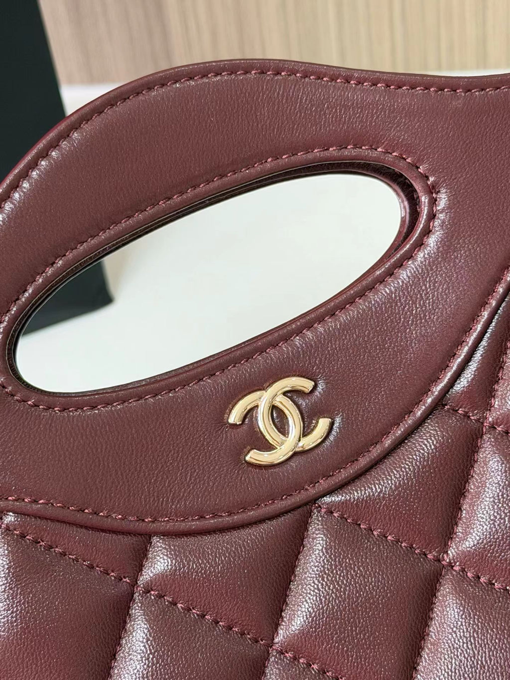 Burgundy quilted mini handbag logo detail
