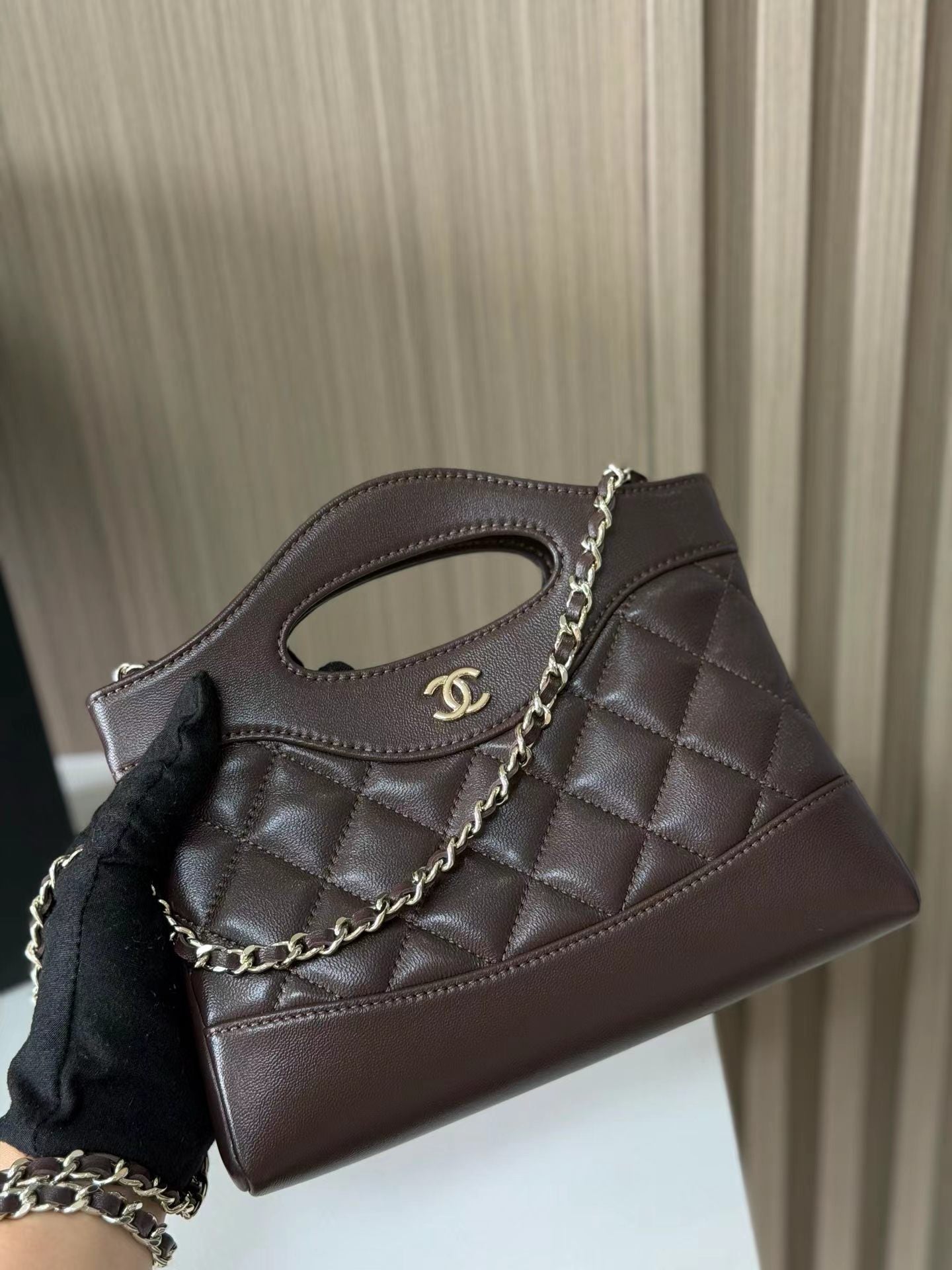 Dark brown quilted mini handbag front view