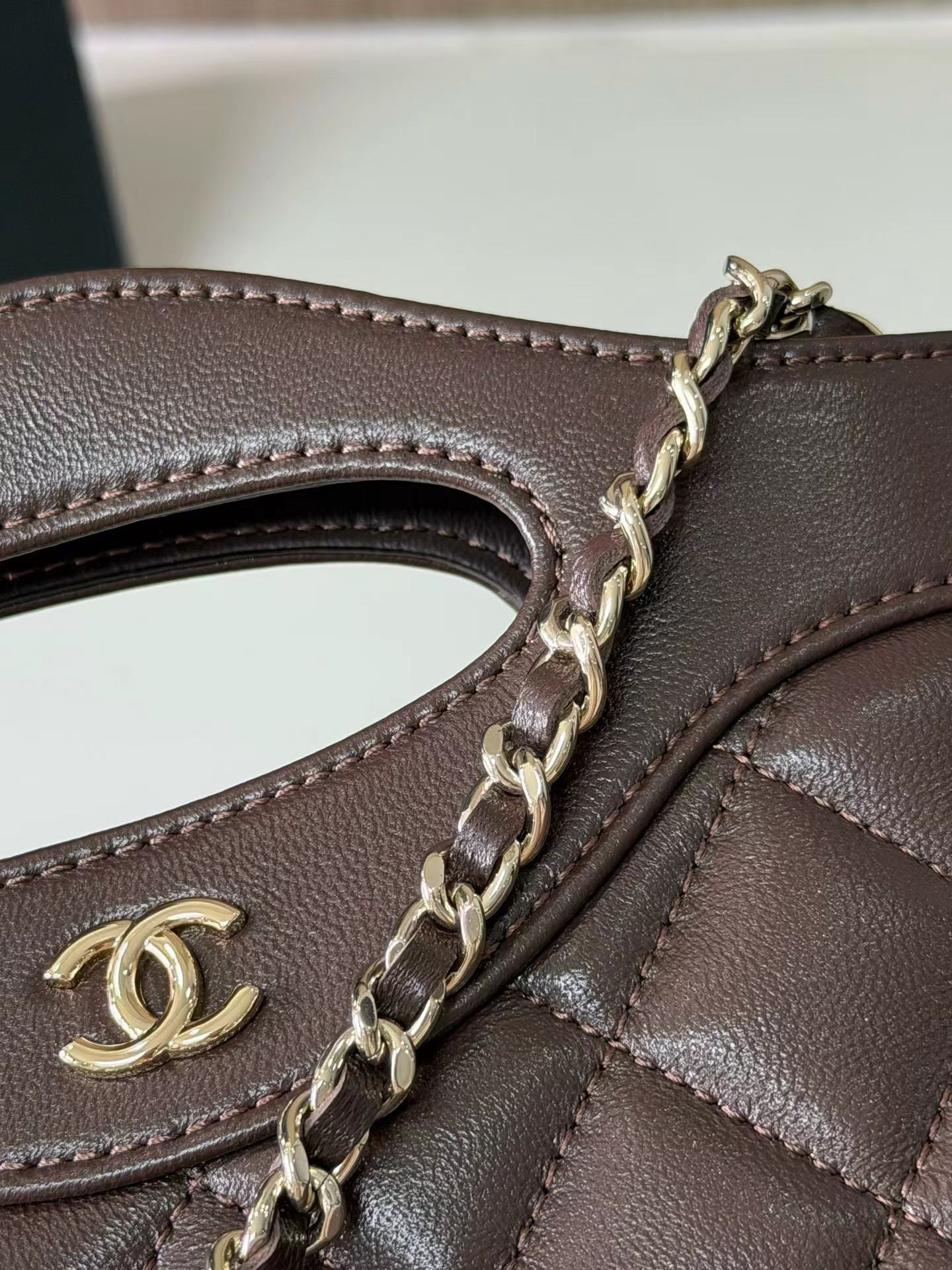 Dark brown mini handbag chain and logo detail