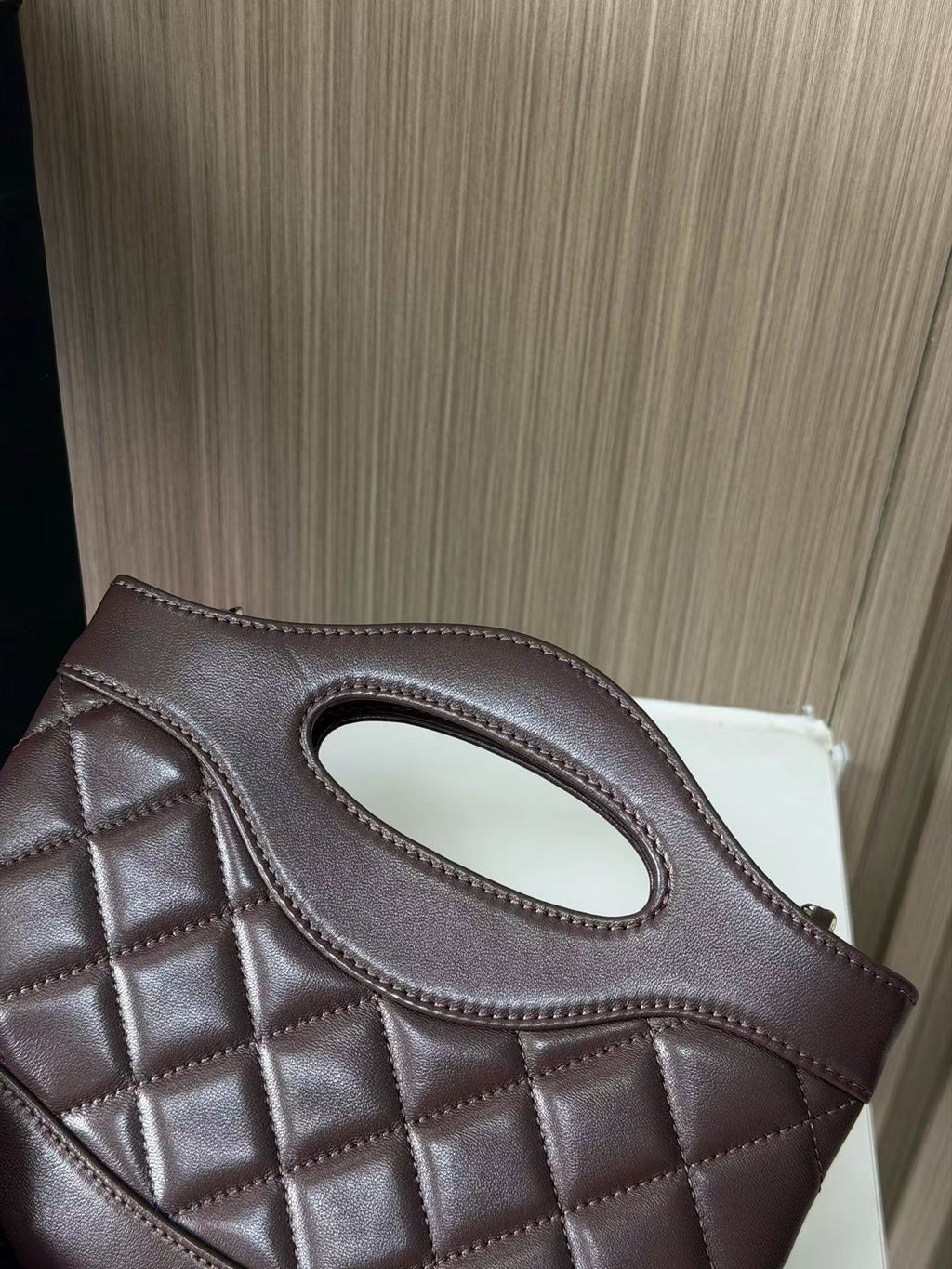Dark brown quilted mini handbag back detail