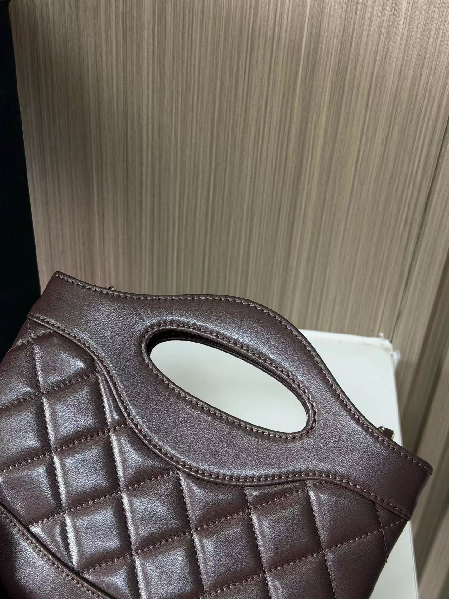 Dark brown quilted mini handbag back detail