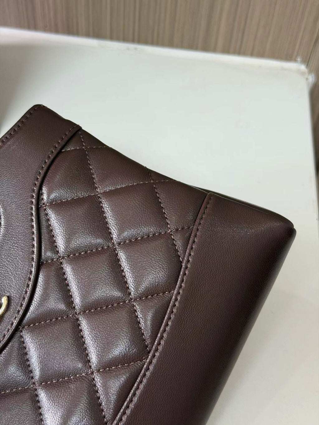 Dark brown quilted mini handbag stitching detail