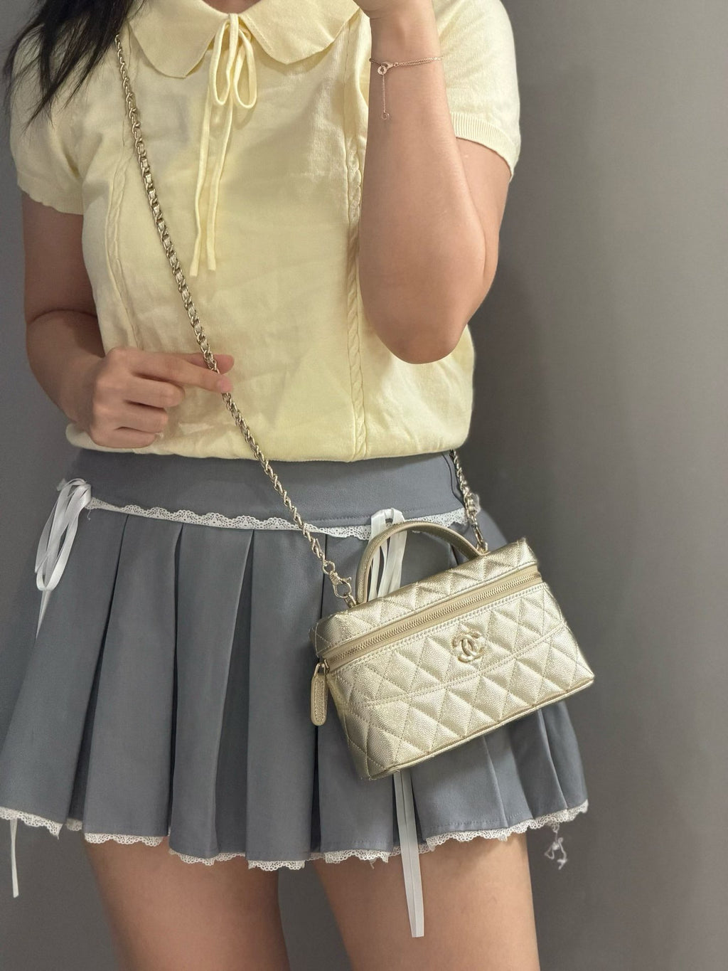 Gold quilted mini handbag shoulder view