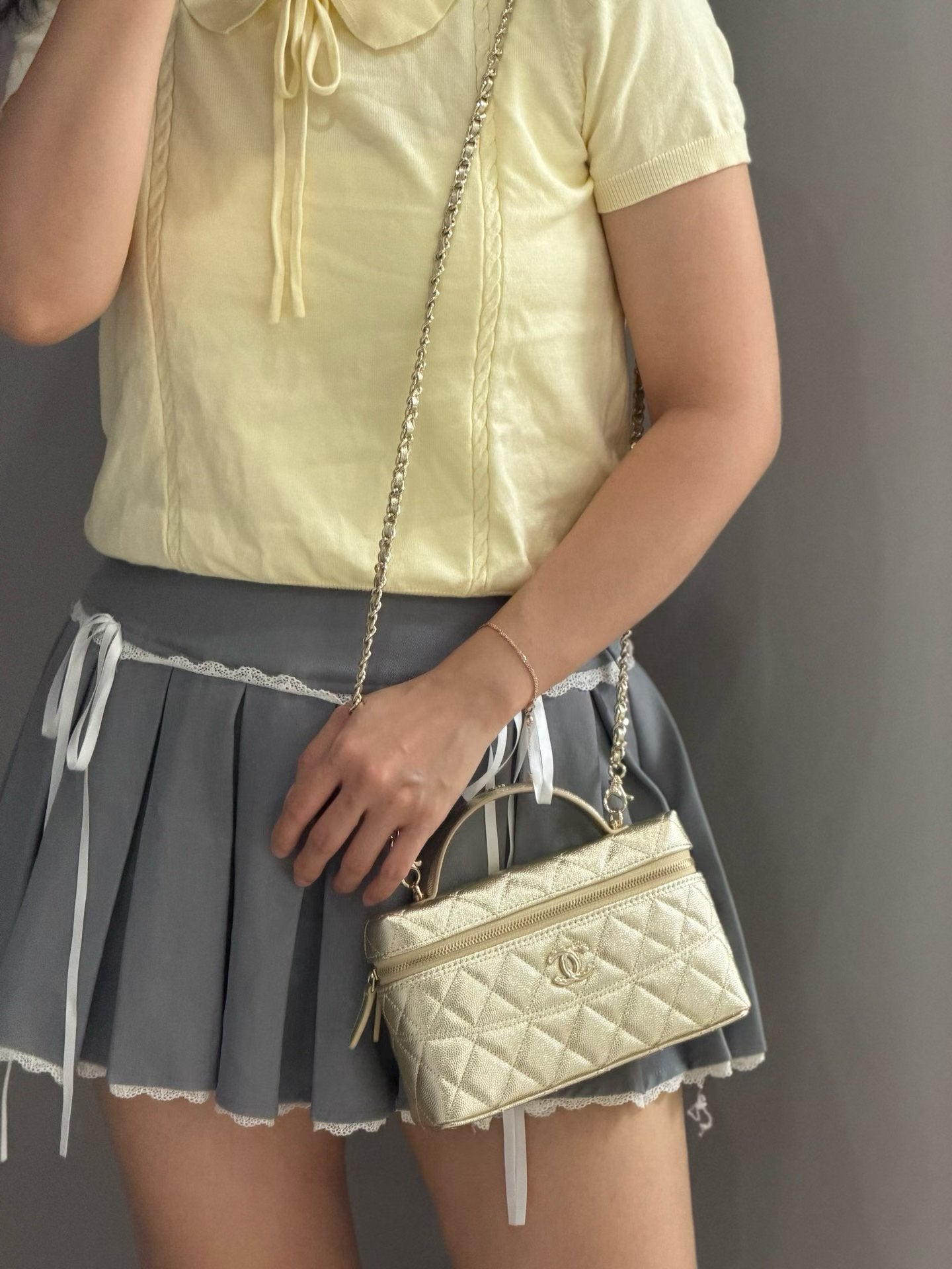 Gold quilted mini handbag crossbody view