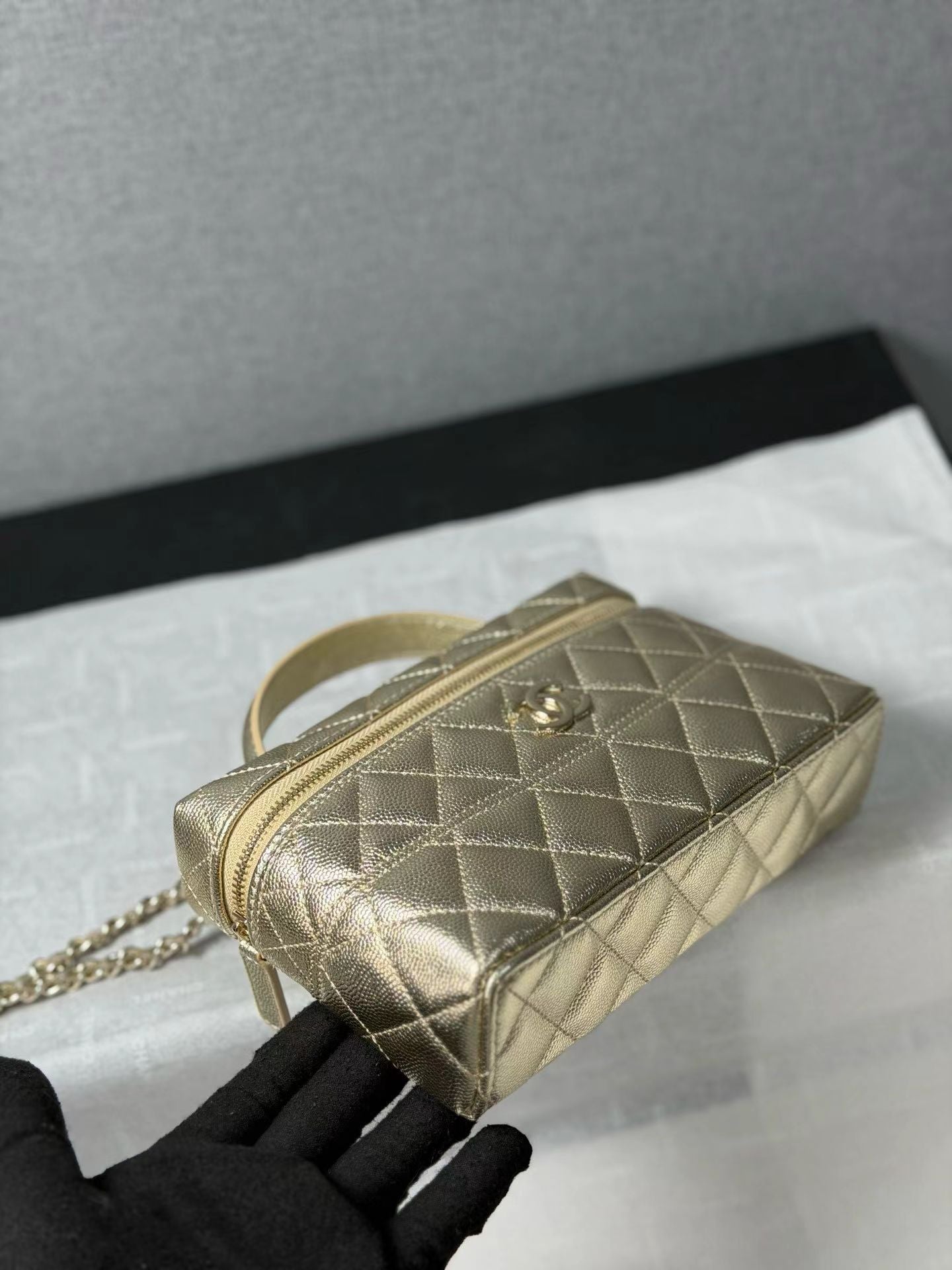 Gold quilted mini handbag bottom detail