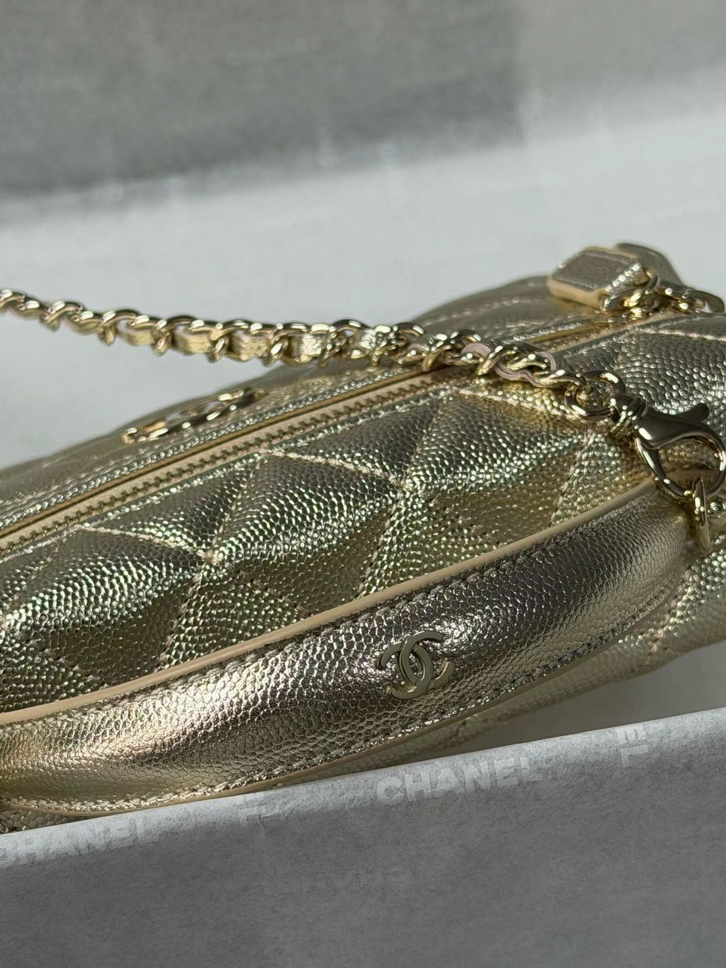 Gold handbag chain and hardware detail