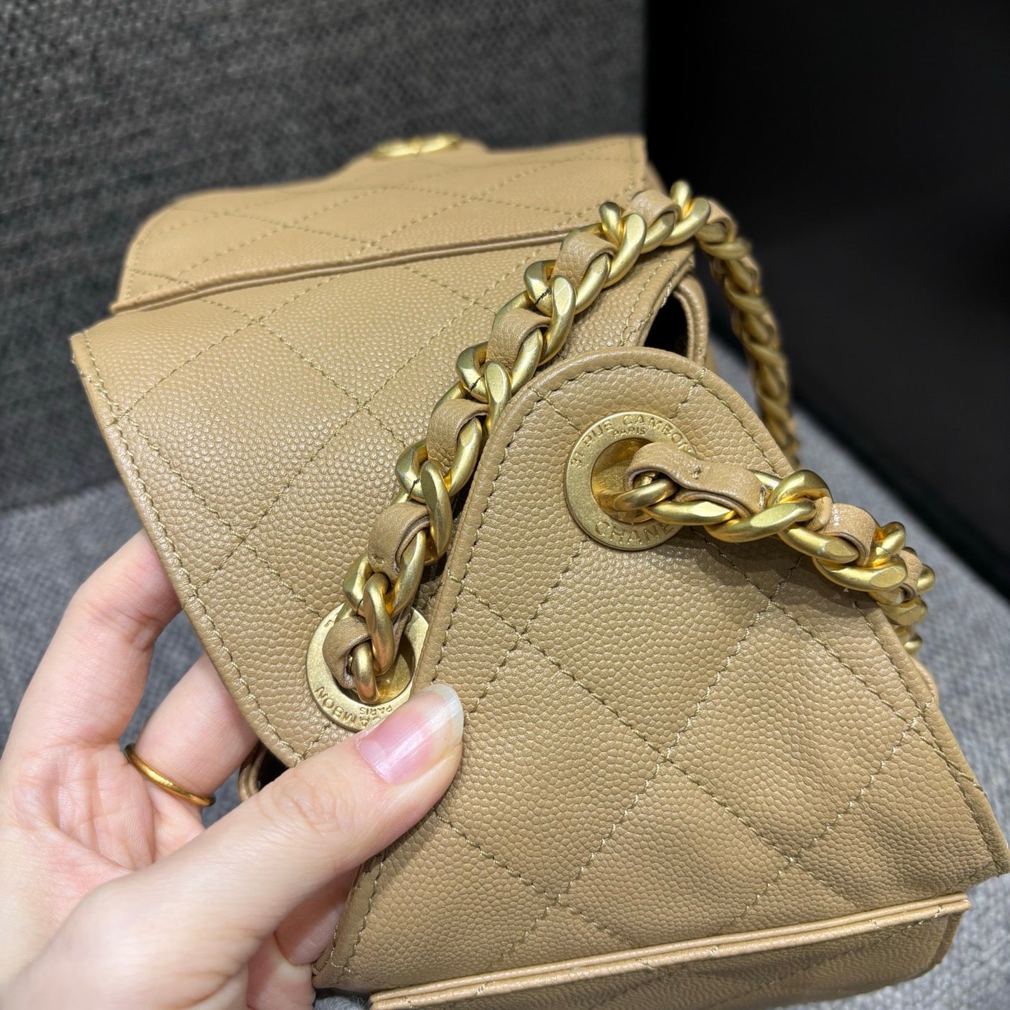 Chanel beige bucket bag chain and grommet detail