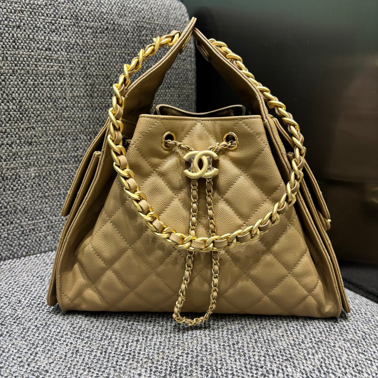 Chanel quilted drawstring bucket bag in beige, front view