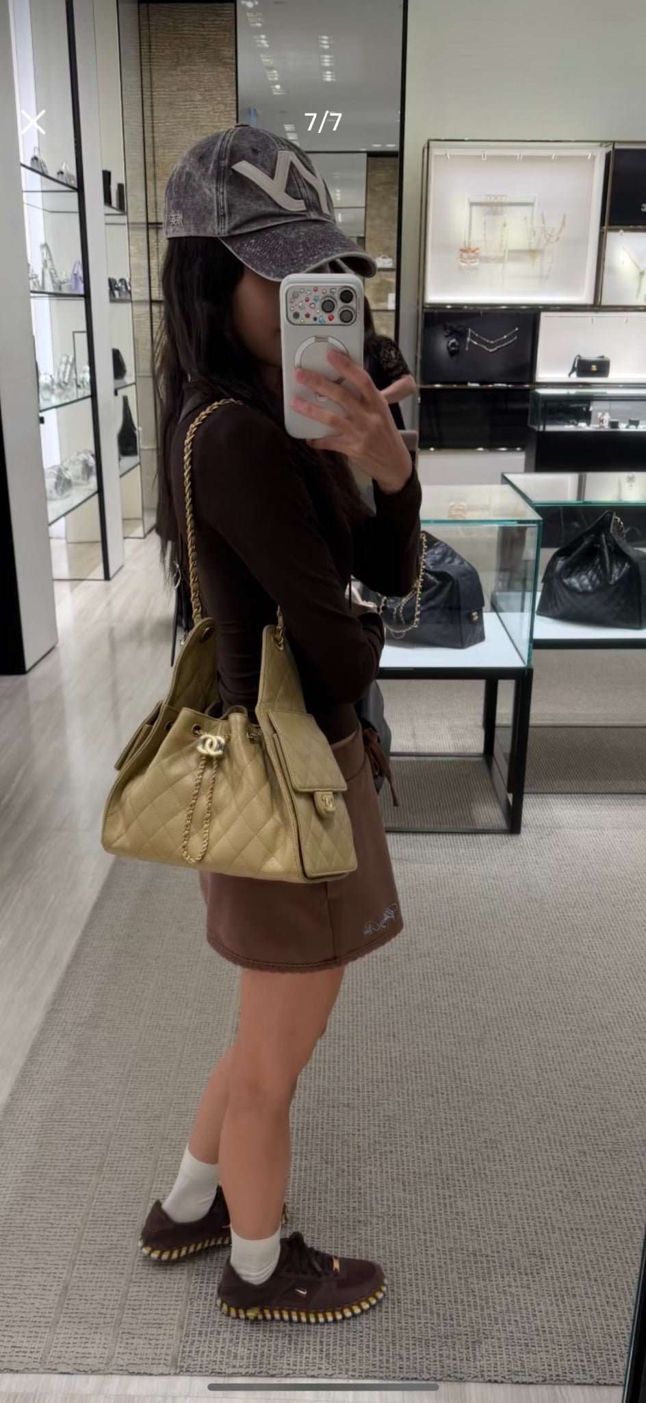 Model wearing the Chanel beige quilted drawstring bucket bag