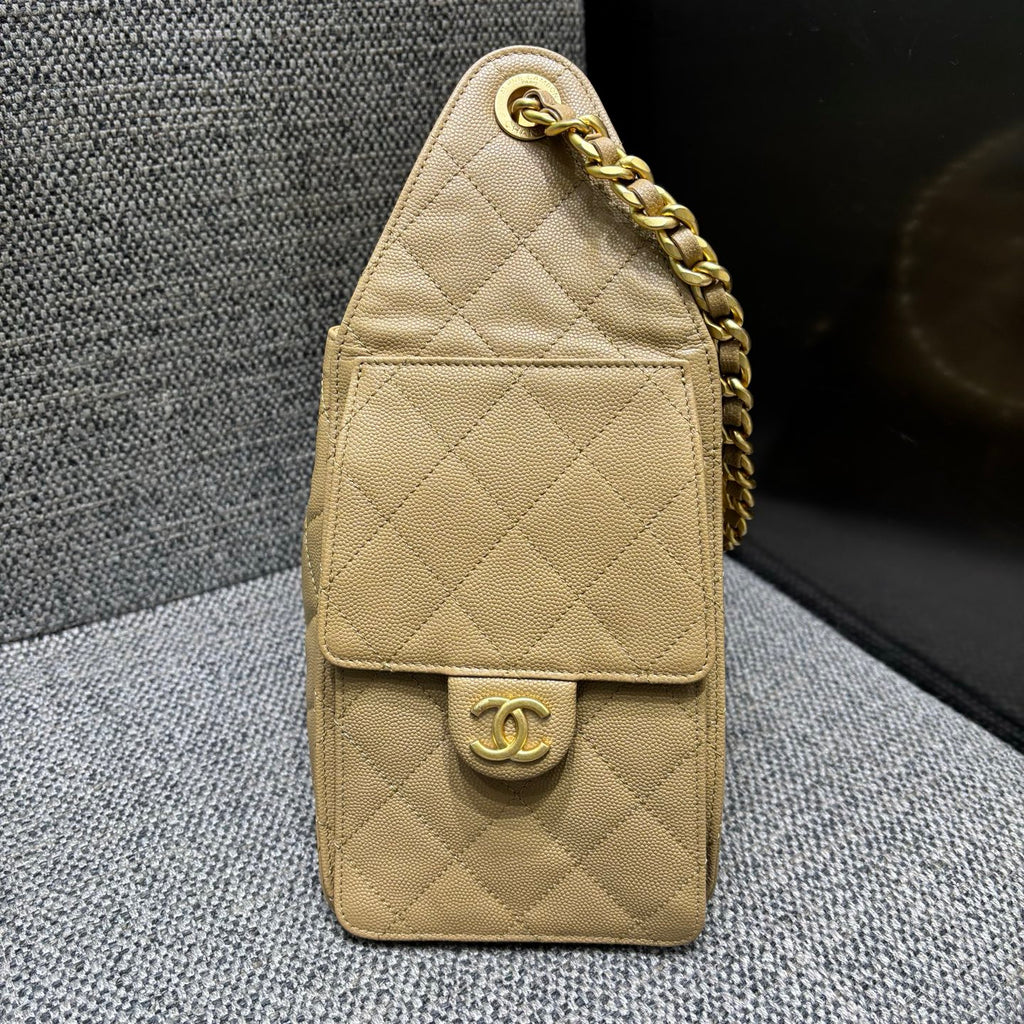 Chanel beige bucket bag side pocket detail
