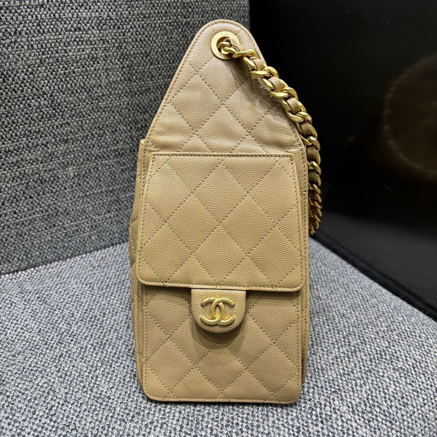 Chanel beige bucket bag side pocket detail