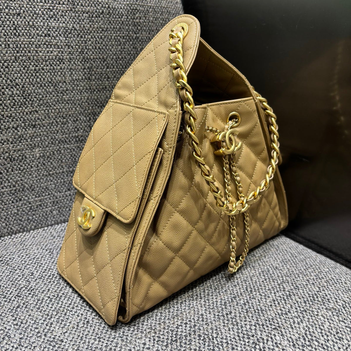 Chanel beige quilted bucket bag, side view